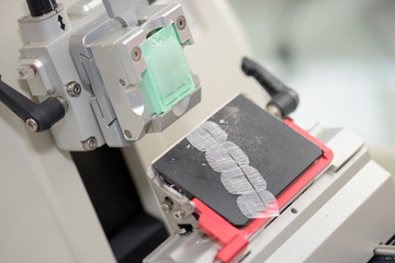 Closeup of machine producing thin squares