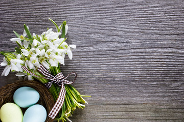 Bouquet of snowdrops flowers with easter eggs.