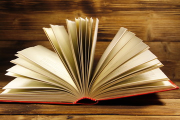 Open book on wooden background