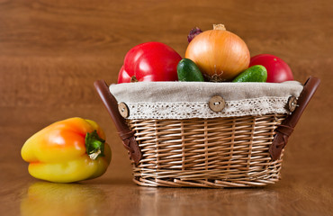 Fototapeta na wymiar Fresh vegetables, peppers, tomatoes in basket