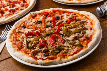 Pizza with tuna fish, bell pepper and olives.