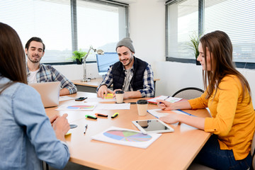 group of young cool hipster business people in casual wear working together in meeting room of a startup company