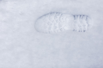 Closeup of a foot print in the snow