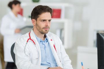 handsome young doctor at work in his office