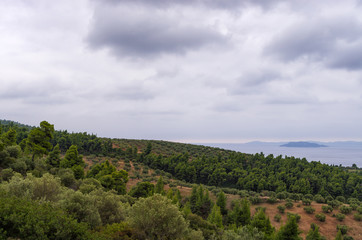 Fototapeta premium Cloudy sky over the hills and sea in Sithonia, Chalkidiki, Greece