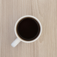 top view of a cup of coffee on a wooden table