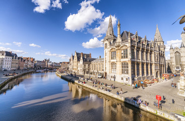 GENT, BELGIUM - MARCH 2015: Tourists visit ancient medieval city. Gent attracts more than 1 million people annually - obrazy, fototapety, plakaty