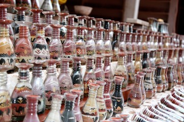 Traditional souvenirs in bottles with sand shows desert and camels, Petra in Jordan 