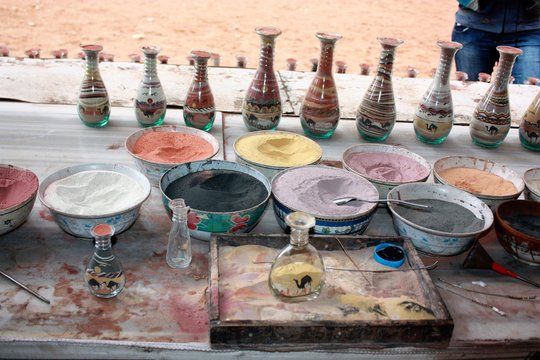 Traditional souvenirs in bottles with sand shows desert and camels, Petra in Jordan 