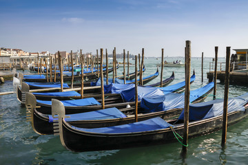 Fototapeta na wymiar Gondolas moored in front of Saint Mark square in Venice