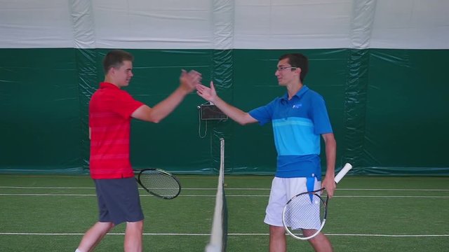 Tennis players shake the hand on court before the match