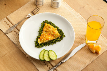 Healthy vegetarian breakfast with omelet made with vegetables and eggs fresh orange juice. Fast cooking lunch with organic ingredients.