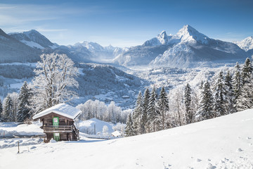 Winter wonderland in the Alps with traditional mountain chalet