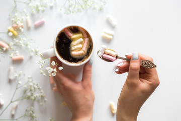 coffee with marshmallows, and women's hands the view from the top