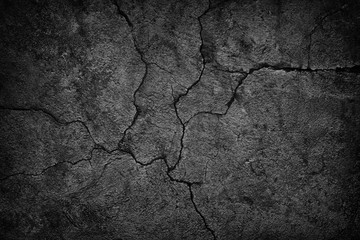 cracked concrete wall covered with black cement texture as background for design