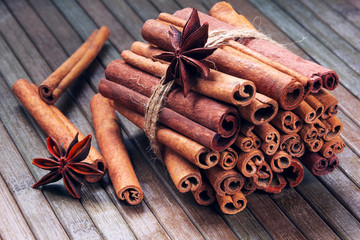 star anise and cinnamon sticks in a bunch on a wooden background