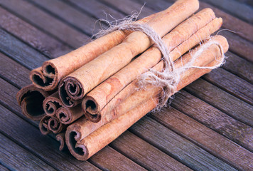cinnamon sticks in a bunch on a wooden background