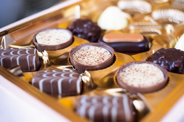 Some assorted chocolates in a box. Selective focus.