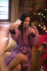 woman drinking doing selfy at spa