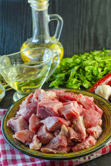 Raw meat chopped into pieces on a plate