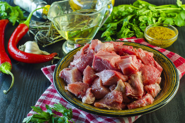 Raw meat chopped into pieces on a plate
