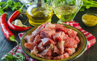 Raw meat chopped into pieces on a plate