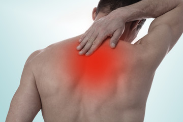 Muscular Man suffering from back and neck pain. Incorrect sitting posture problems Muscle spasm,...