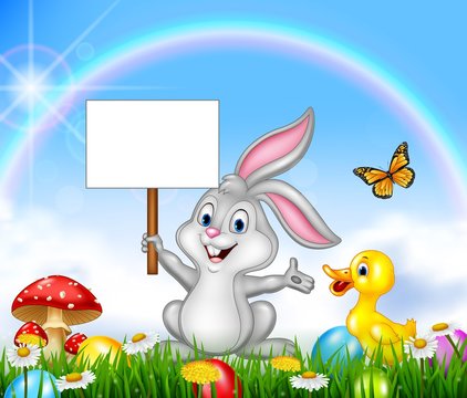 Happy little bunny holding blank sign with Easter background