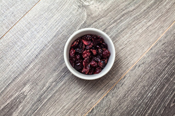 Dried Cranberries in a bowl on a wooden table