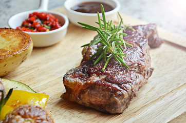 Grilled steak with vegetables on cutting board