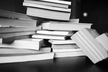 A lot of books are on the table. Black and white photo