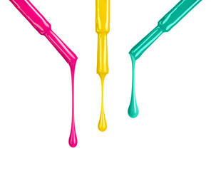 Colored nail polishes dripping from brushes isoalted on white background