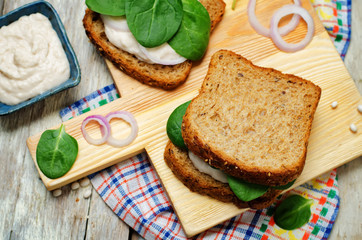 White bean hummus spinach rye sandwich