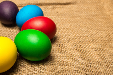 Colored Easter eggs on a rustic background