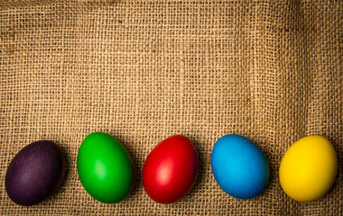 Colored Easter eggs on a rustic background