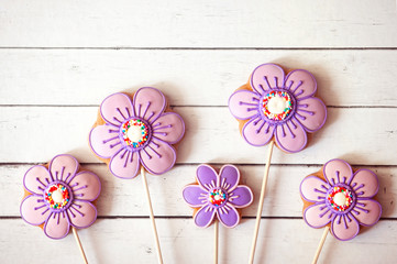 Easter sweets, flower shaped gingerbread cookies on a white wooden table. Happy Easter home-baked cookies 