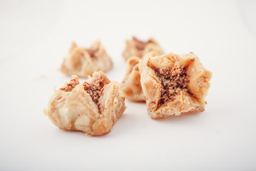 Arabian Eid dates sweets isolated. Oriental sweets with honey and nuts. Turkish Pakhlava Isolated On White. Turkish dessert.