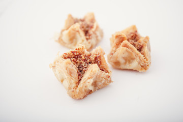 Arabian Eid dates sweets isolated. Oriental sweets with honey and nuts. Turkish Pakhlava Isolated On White. Turkish dessert.