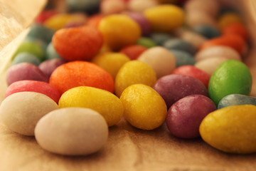 Round candy in a paper bag on the table