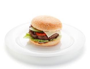 Big burger on a white plate isolated on white background.