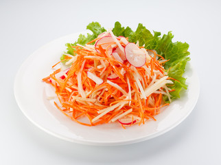Vegetable salad on a white plate isolated on white background.