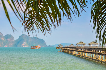 Ship with tourists near the pier in Phang Nga Bay