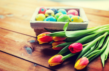 close up of colored easter eggs and flowers