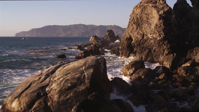Close flight past rocks on the rugged Catalina coast. Shot in 2010.