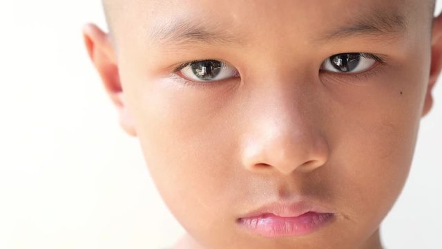 closeup of a young Asian boy's sad face