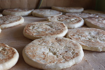 women bake Turkish flatbread , bazlama
