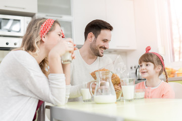 Obraz na płótnie Canvas Happy family having breakfast at home