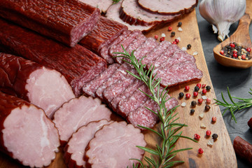 Set of cold cuts on a wooden board. Mix of sausages