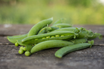 Green peas on wooden background