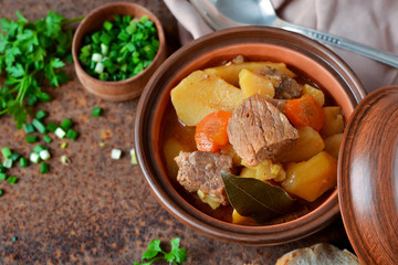 Stew with vegetables and potatoes on an old grunge background